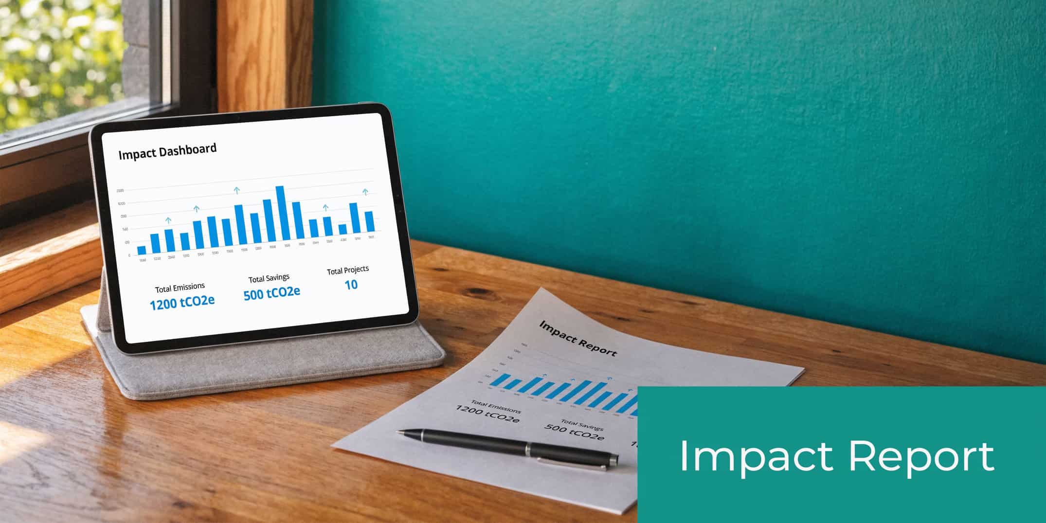 Tablet and printed report displaying impact dashboard metrics on a wooden table beside a window