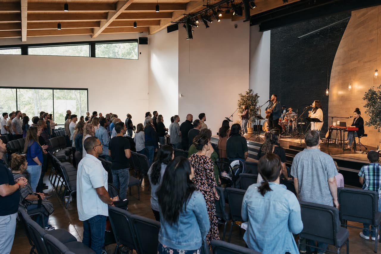 Modern church congregation participating in a contemporary worship service with a live band