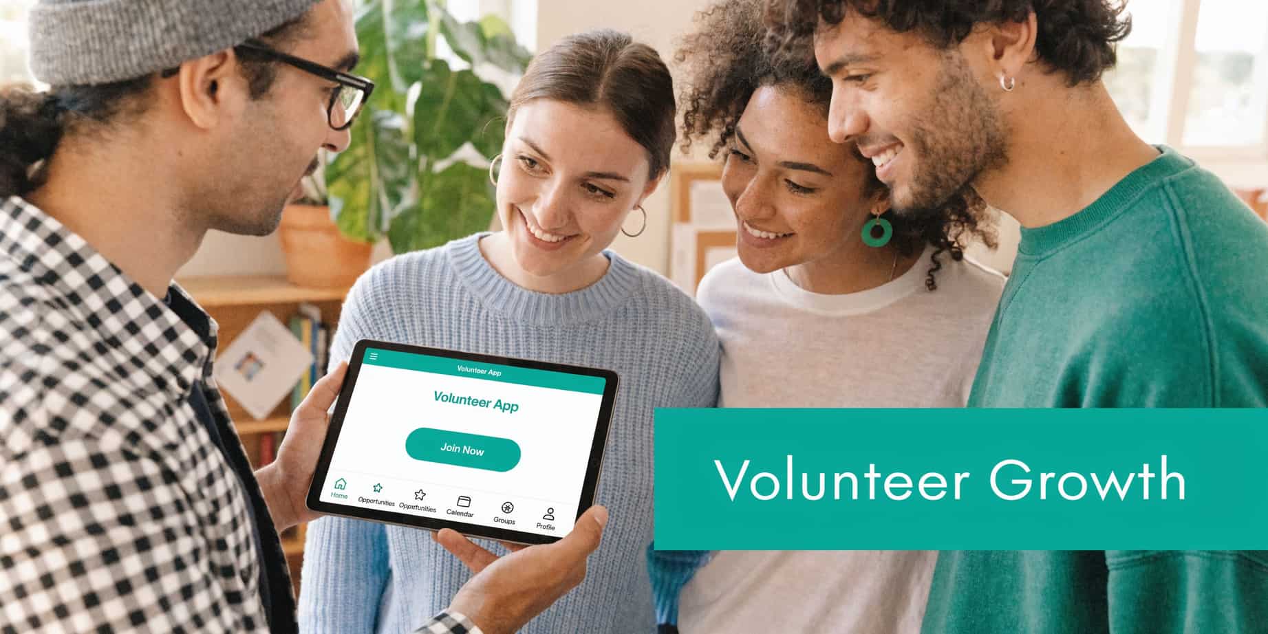 Group of young volunteers looks at a tablet screen showcasing the Volunteer App interface together.