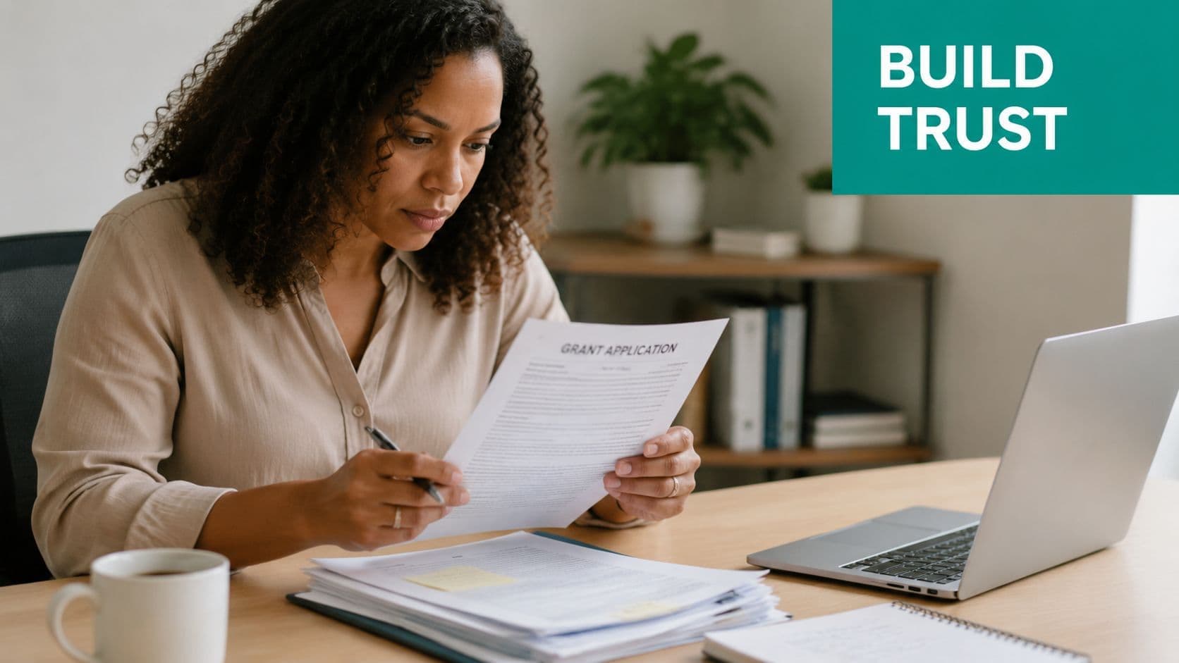 Woman with curly hair focused on reviewing a grant application document at her office desk