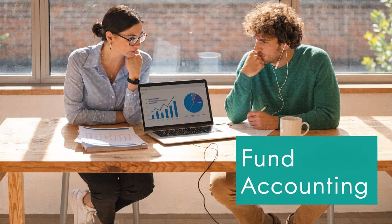 Woman and a man reviewing financial charts and data on a laptop in an office