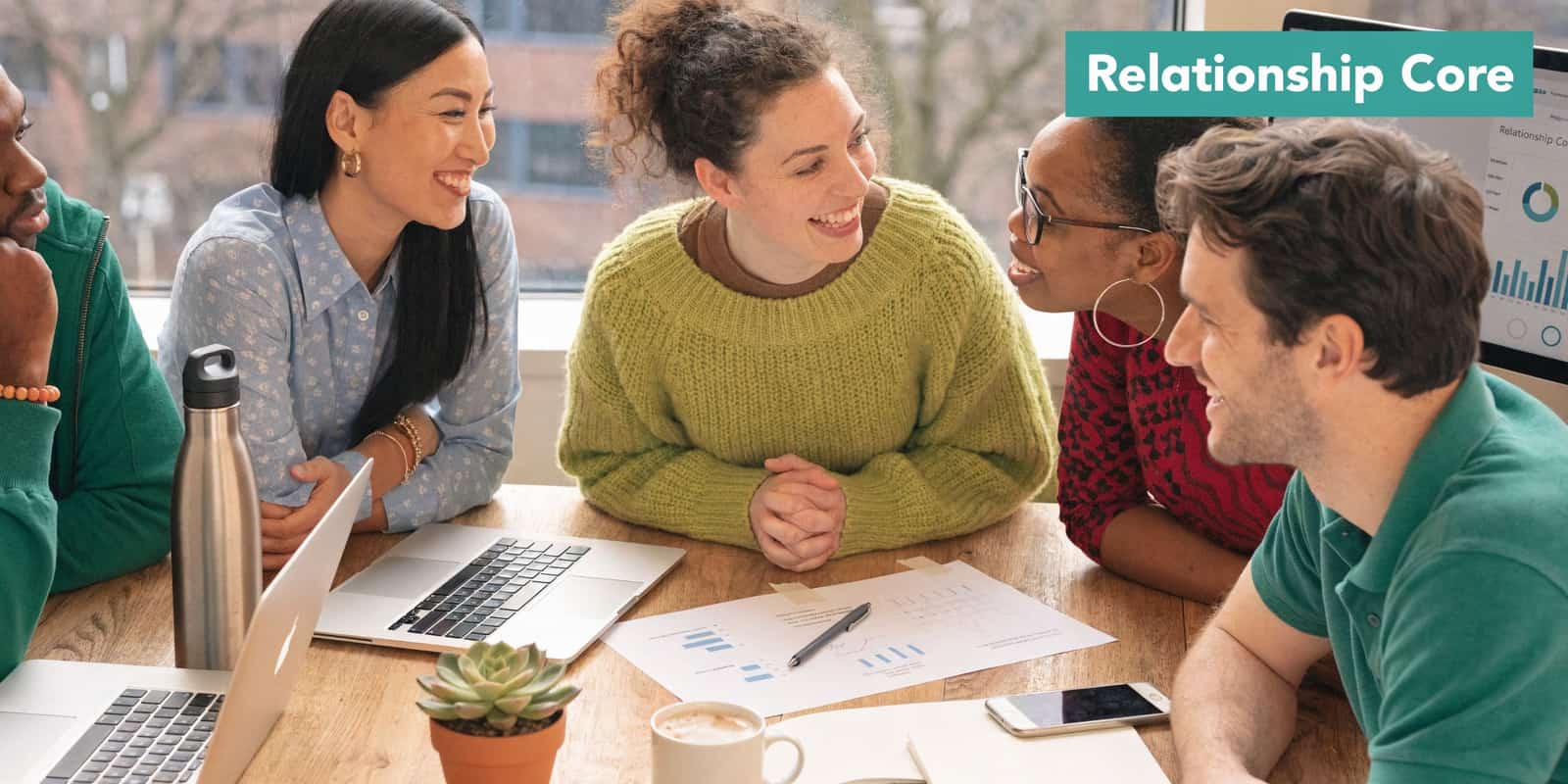 Nonprofit colleagues collaborating on a CRM project around an office table