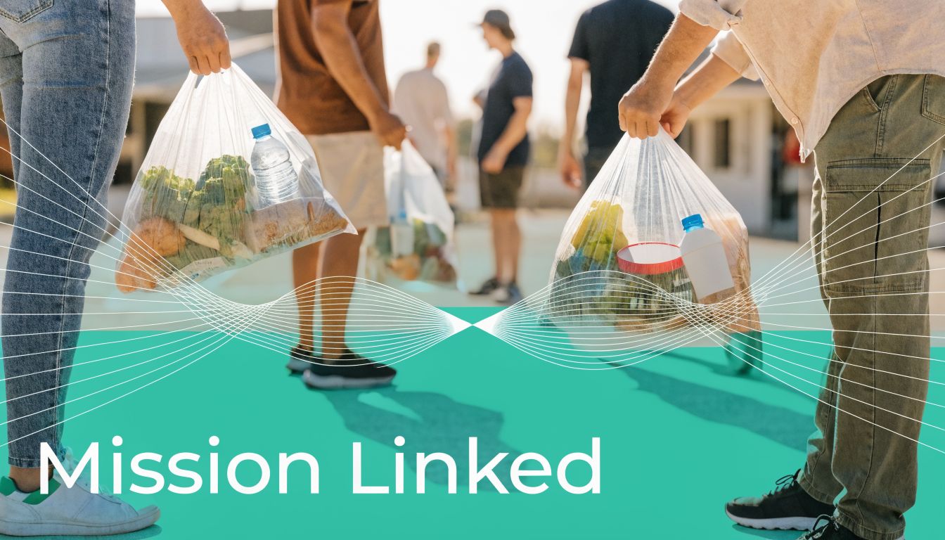 A group of volunteers carrying plastic bags filled with groceries during a community food donation event.